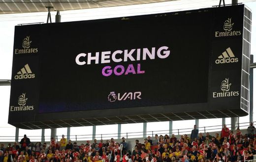 A scoreboard shows that VAR is checking a possible goal