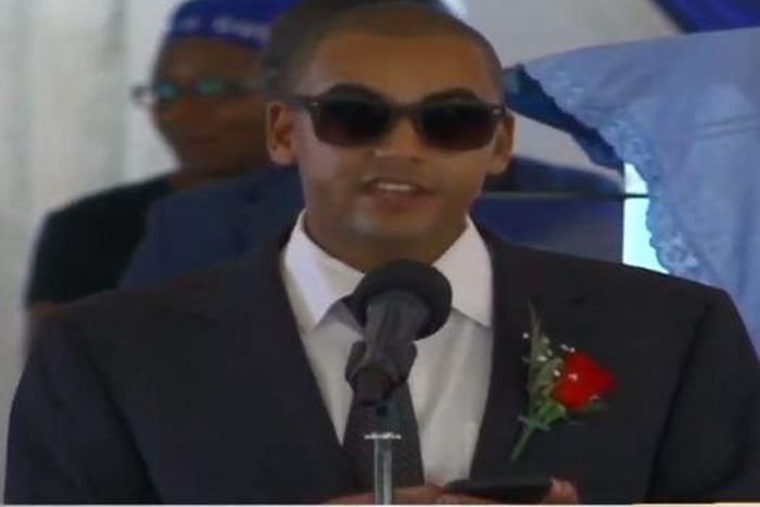 Andrew Kenneth lights up mourners at his grandmother, Rahab Muhuni's burial in Kirwara Gatundu
