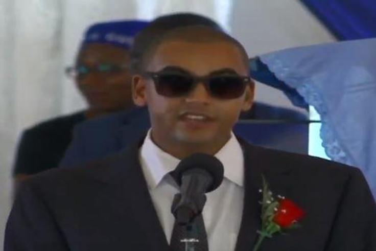 Andrew Kenneth lights up mourners at his grandmother, Rahab Muhuni's burial in Kirwara Gatundu