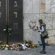A woman stands next to flowers laid next to the entrance of the synagogue in Munich, dring a protest against anti-Semitism on October 11, 2019 two days after a deadly shooting during an attack in Halle targeting a Turkish restaurant after an attempt at...