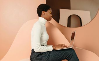 A digital creator working on her laptop [Image Credit: Anastasia Shuraeva]