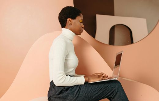 A digital creator working on her laptop [Image Credit: Anastasia Shuraeva]
