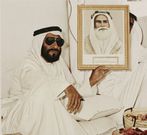 Sheikh Zayed bin Sultan bin Zayed bin Khalifa Al Nahyan (ruler of Abu Dhabi from 1966, president of UAE 1971 - 2004) holding a portrait of his grandfather Sheikh Zayed (ruler of Abu Dhabi 1855 to 1909)