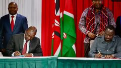 President William Ruto and Raila Odinga signing a political pact at KICC on March 7, 2025 with DP Kithure Kindiki and Senator Ledama Ole Kina standing in the background