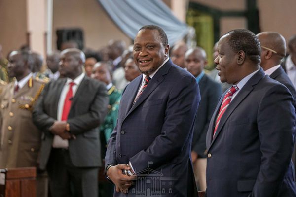 File image of retired President Uhuru Kenyatta with Fred Matiang'i who served in his cabinet