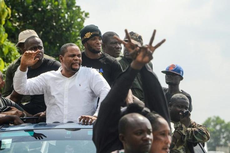 Liberian radio show host and opposition leader Henry Costa (2nd L) is one of those behind the anti-government protests
