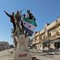 Turkish-backed Syrian rebels celebrate their recapture of the stategic crossroads town of Saraqib in a counterattack that reversed one of the main gains of a government offensive on their last major stronghold
