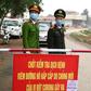 Vietnamese police stand guard at a checkpoint set up at the Son Loi commune in Vinh Phuc province amid concerns about a COVID-19 coronavirus outbreak