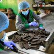 Workers at al-Arees sweets factory in Gaza City sort a batch of chocolate-covered biscuits