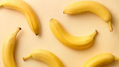 Directly Above Shot Of Bananas Over Beige Background