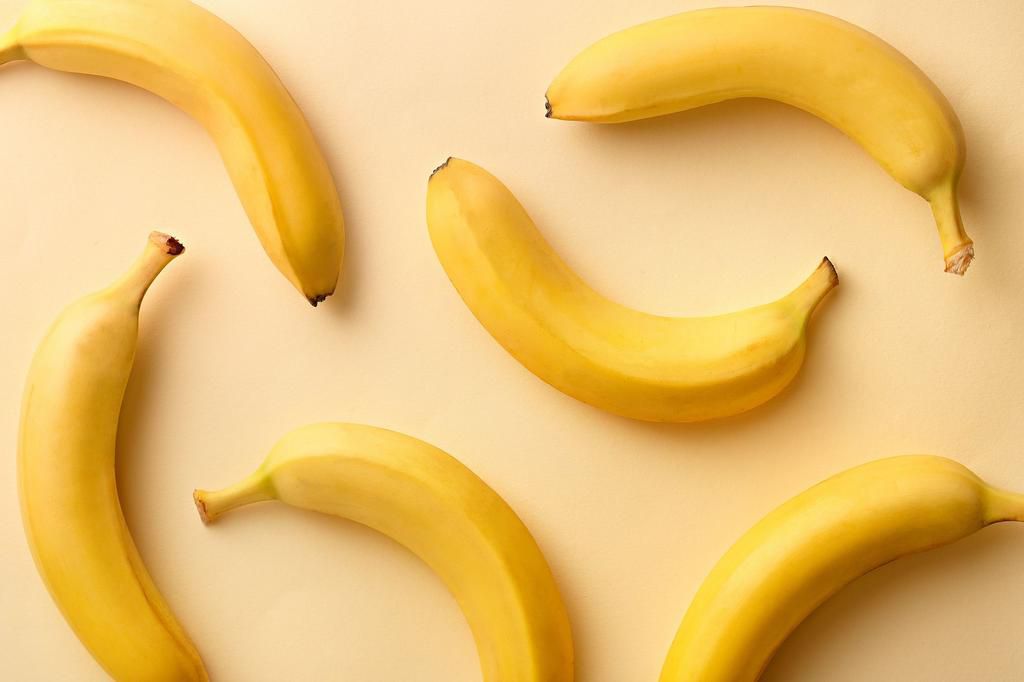 Directly Above Shot Of Bananas Over Beige Background