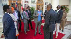 File image of Dennis Itumbi with President Uhuru Kenyatta and other dignitaries at a past event