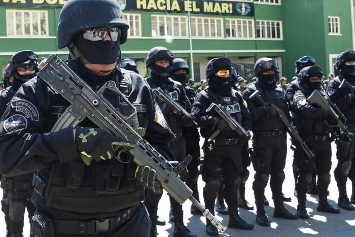 Members of Bolivia's GAT anti-terrorist unit stand guard as they are presented in La Paz, on December 3