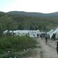No running water, putrid portable toilets and surrounding woods littered with land mines -- these are the bleak conditions of a camp where hundreds of migrants are bracing for winter in Bosnia