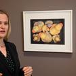 Curator Laura Mart highlights a photograph of rubber ducks, some caked in mud -- a seemingly sentimental choice, but with a pragmatic purpose