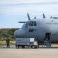 A man stands next to a C-130 plane that returned to Punta Arenas, Chile, from a search of the Drake Passage for a missing Air Force plane with 38 people aboard