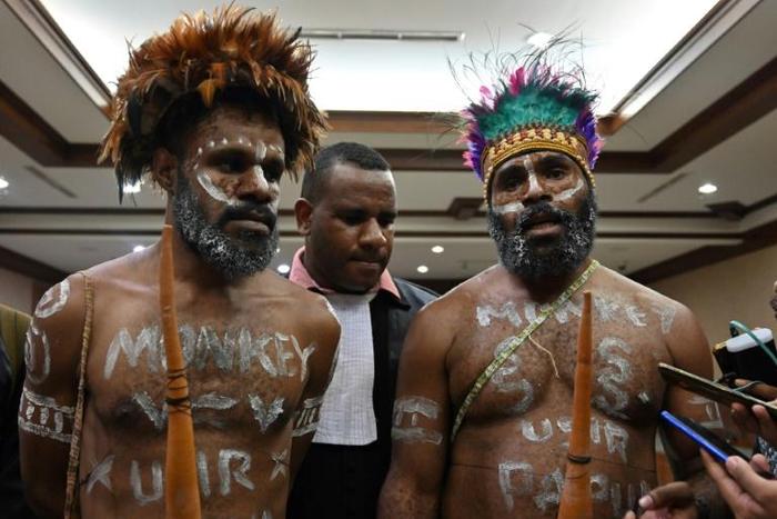 Papuan activists Ambrosius Mulait (left) and Dano Anes Tabuni speak to journalists during their trial in Jakarta
