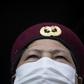 Security guards in Hangzhou take details from residents in order to enforce the limits on outbound trips