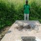 Louis Marie Mang, a UPC activist, stands before the tomb of anti-colonialist leader Ruben Um Nyobe