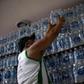 In this file photo taken on January 15, 2020, a man buys bottled water at a liquor store in the Lapa neighborhood of Rio de Janeiro