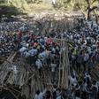 Hundreds had been sitting on a tiered wooden structure for hours when it collapsed