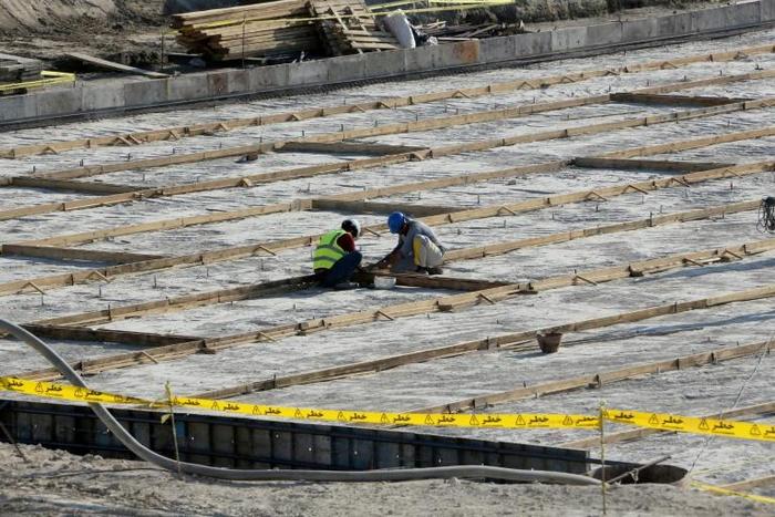 The particles are understood to be the product of uranium which has been mined and undergone initial processing, but not enriched; A picture taken on November 10, 2019, shows workers on the construction site of a second reactor in the Bushehr nuclear p...