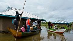 Rescue boats evacuate families after their houses were flooded in Kenya