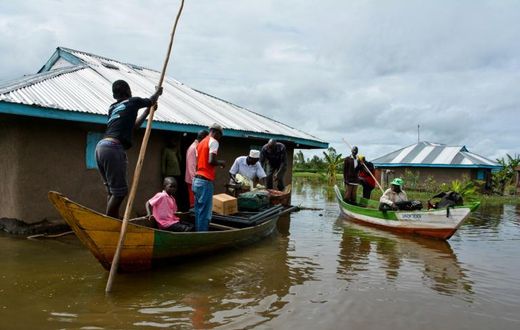 Rescue boats evacuate families after their houses were flooded in Kenya