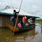 Rescue boats evacuate families after their houses were flooded in Kenya