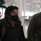 Wall Street Journal reporters Philip Wen (left) and Josh Chin walk through Beijing Capital Airport on their way out of China