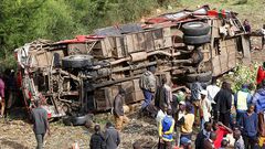 Bus rolls off a bridge