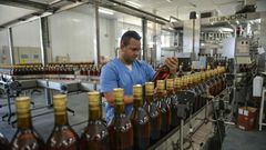 A worker checks bottles of rum at the Havana Club production plant in San Jose de las Lajas, Cuba