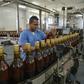 A worker checks bottles of rum at the Havana Club production plant in San Jose de las Lajas, Cuba