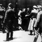 SS soldiers lead newly arrived prisoners to the gas chambers at the Auschwitz concentration camp. The death camp remains an enduring symbol of the Holocaust.