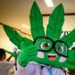 A cannabis plant mascot entertains patients at the opening of a medical marijuana clinic in Bangkok
