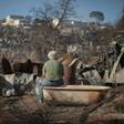 A man looks at the destruction caused by a forest fire on Rocuant hill in Valparaiso, Chile, on December 25, 2019