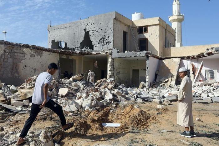 Libyans check the site of an air strike that killed three children in October, 2019 on the outskirts of the capital Tripoli as forces of eastern strongman Khalifa Haftar battled forces loyal to the UN-recognised Government of National Accord (GNA)