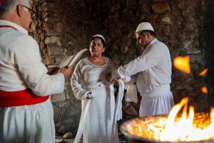 Iraqi Kurd Faiza Fouad takes part in a ritual ceremony in an ancient and ruined temple as she joins the millennia-old Zoroastrian religion