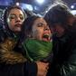 Activists in favor of abortion rights comfort each other outside the National Congress in Buenos Aires after senators rejected the bill to legalize the abortion in 2018