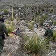 Border patrol agents Arain Carrera and Thaddeus Cleveland approach an injured Guatemalan migrant in a remote canyon of west Texas