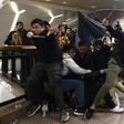 Police react as anti-government protesters throw an umbrella at them on Christmas Eve in the Tsim Sha Tsui district of Hong Kong