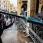 Anti-government protesters use a road sign to taunt security forces taking cover during clashes in the central downtown district in Beirut on Saturday