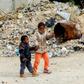 Libyan children play outside an unfinished building which has become home to many displaced families in Tripoli