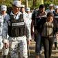 A Central American migrant family is escorted by members of the Mexican National Guard and officers of the Migration Institute after being detained crossing the Suchiate River, in Mexico