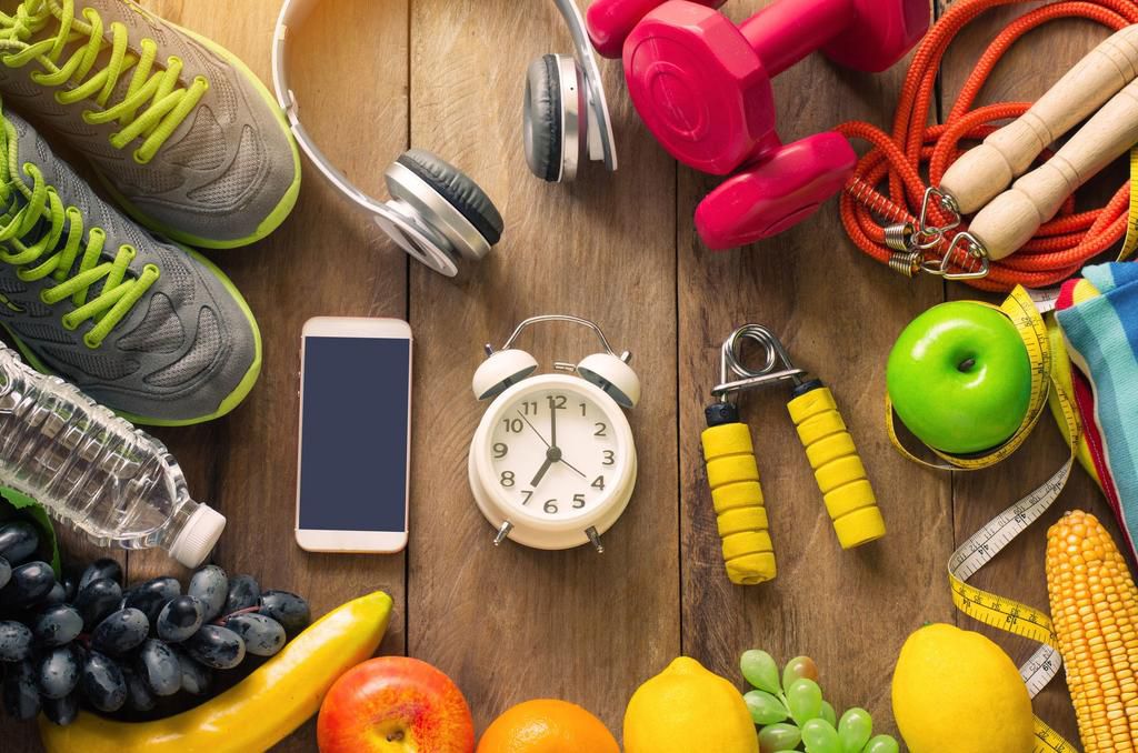 High Angle View Of Various Fruits With Exercise Equipment On Table