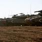 Israeli tanks stand guard close to the armistice line with Syria on the strategic Golan Heights
