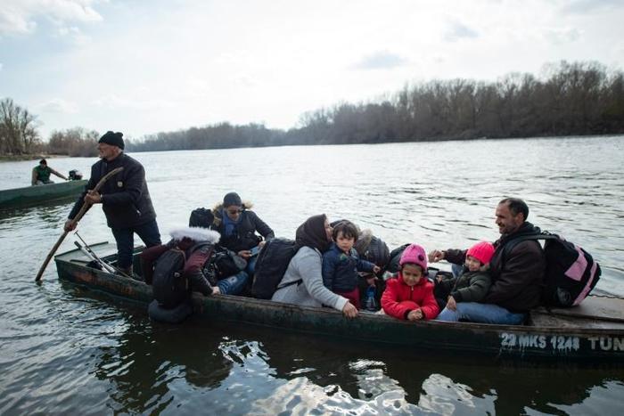 Migrants near Edirne in northwestern Turkey try to reach Greece by crossing the Maritsa river, on March 1, 2020. Thousands more reached the Turkish border with Greece after Turkey's President threatened to let them cross into Europe