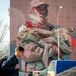 A mural in Almaty depicts Yerlan Nurgaliyev cradling a baby saiga antelope