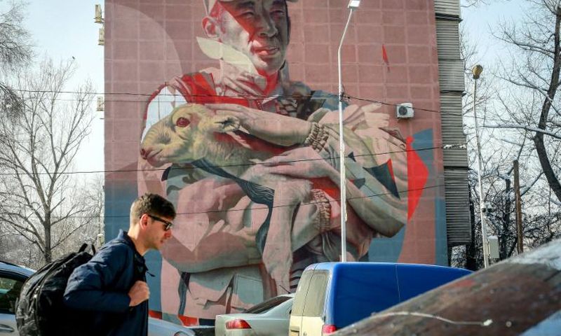 A mural in Almaty depicts Yerlan Nurgaliyev cradling a baby saiga antelope