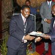 File image of Mwangi Kiunjuri receiving a report from DP Ruto during the opening of the comprehensive agriculture development programme at Safari Park hotel in Nairobi on June 12, 2019.